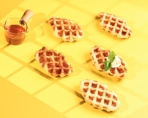Croissant Waffle with Mapple Syrup in Yellow Table. Croffle is Viral Cake from South Korea. Concept Pop Color Food, Copy Space for Text