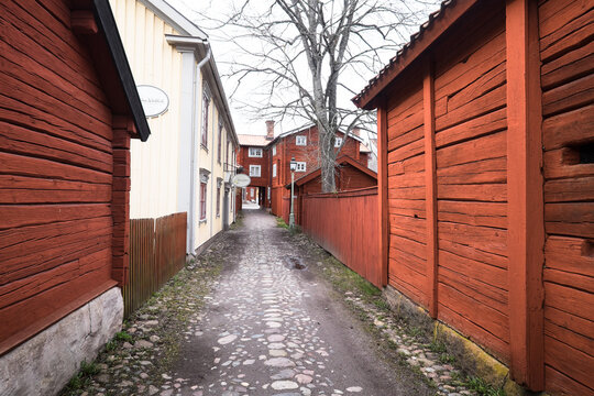 LINK&Ouml;PING, SWEDEN, MARCH 14, 2020: View of traditional timber houses with deep Falu red or falun red paint in the old town Gamla Linkoping, Sweden