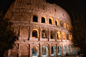 Naklejka premium Colosseum in Rome in the night. travel directions and rest in Italy. Europe sightseeing landmarks and tourism