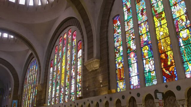 Elegant Interior Of Church Sainte-Odile With Multicolored Wide Stained-Glass Windows. Monument In Paris, France. low angle, sliding right