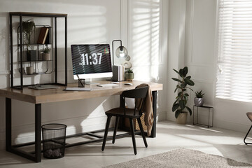 Room interior with comfortable workplace. Modern computer on wooden desk