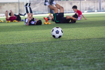 Soccer ball tactics on grass field with children warm up