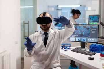 Medicine scientist doing virtual simulation of virus vaccine wearing vr headset. Team of researchers working with equipment device, future, medicine, healthcare, professional, vision, simulator.