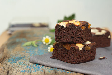 An image closeup cake or brownie chocolate flavor. a nuts sprinkle truffle dessert delicious is bakery tart homemade.