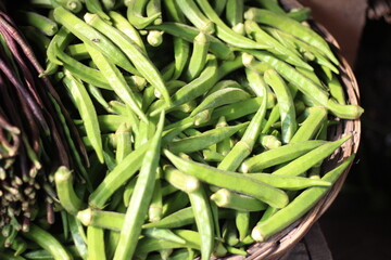 A bunch of lady's finger vegetables in a traditional cage.