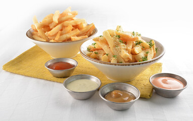 deep fried golden French fries with parmesan cheesy sauce in white background western snack cuisine...
