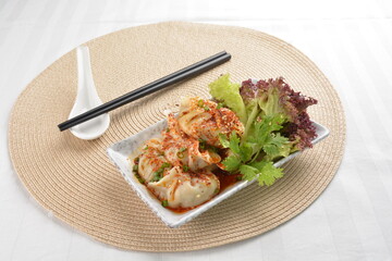 double boiled meat dumpling with spicy mala chilli sauce in white background asian halal menu
