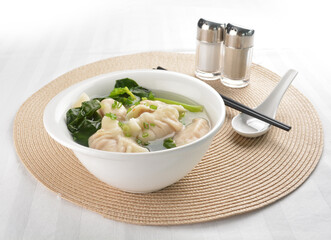 double boiled meat dumpling and vegetables in hot soup bowl in white background asian vegan halal menu