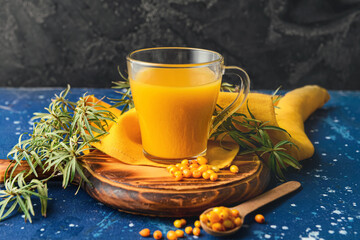 Cup of healthy sea buckthorn tea on table