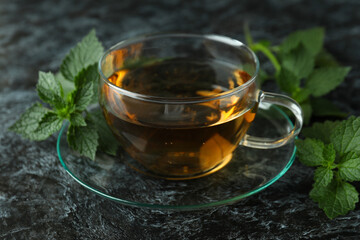 Cup of nettle tea on black smokey table