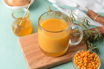 Cup of healthy sea buckthorn tea on table