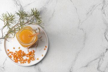 Fototapeta na wymiar Mason jar of healthy sea buckthorn tea on white background