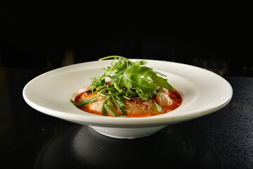 cheesy baked cheese meat ball with red tomato bolognese sauce and green vegetables in dark bar counter background western cuisine halal menu