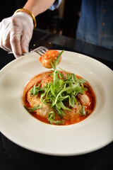 cheesy baked cheese meat ball with red tomato bolognese sauce and green vegetables in dark bar counter background western cuisine halal menu