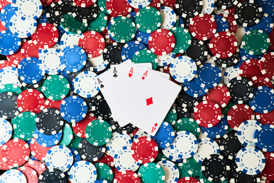 Background made of Casino pocker chips and playing cards