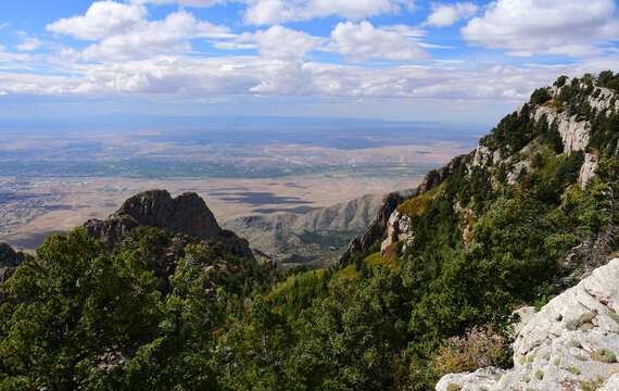 panoramic view of albuquerque, forest, and granite peaks  on a fall day from  sandia peak, new mexico
