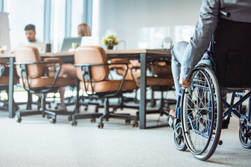 Close up. Disabled Man on Wheelchair in Office. Disabled Young Man. Man on Wheelchair. Recovery and Healthcare Concepts. Teamwork in Office. Young Workers. Sitting Man. Happy Worker.