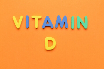 Text VITAMIN D on color background