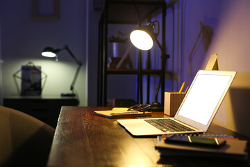 Modern workplace of freelancer in evening