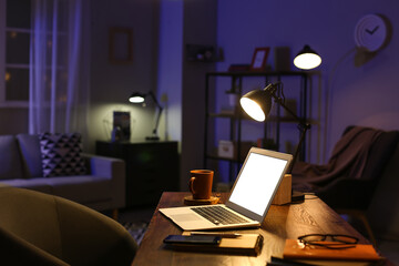 Modern workplace of freelancer in evening