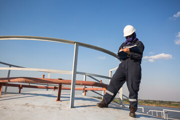 Female worker inspection roof storage tank