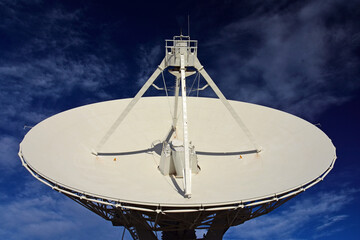 a radio telescope in a giant dish antenna at the karl g. jansky very large array radio astronomy...