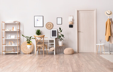 Interior of stylish room with modern workplace and pictures