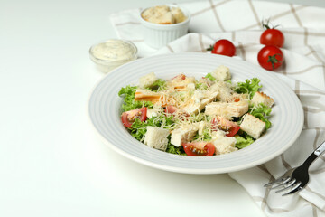 Concept of tasty eating with Caesar salad on white table