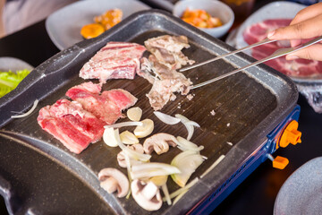 People grilling Korean barbeque