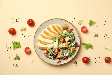 Concept of tasty eating with Caesar salad on beige background