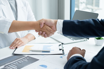 The businessmen shake hands after the meeting was successful and agreed upon