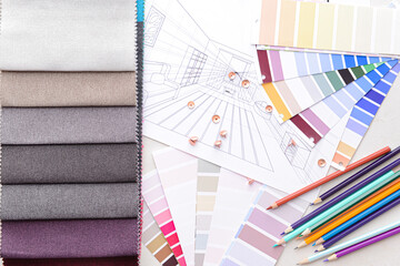 Composition with paint color palettes and fabric samples on white background