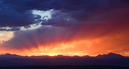 stirring sunset over long's peak and the front range of the  colorado rocky mountains, as seen from Broomfield, colorado