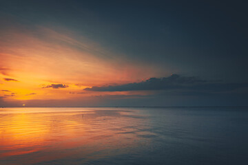 Sunrise, sunset over the beach and ocean waves on a tropical sea.
