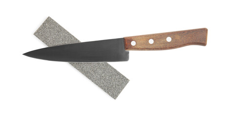 Sharpening stone and knife on white background, top view