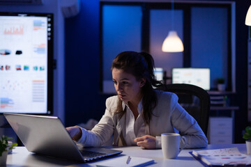 Happy freelancer receving good news on laptop working on financial network in start up company...