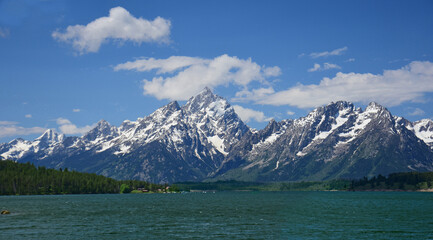 beautiful view of mount moran and the teton range on a sunny summer day  from jackson lake dam in ...