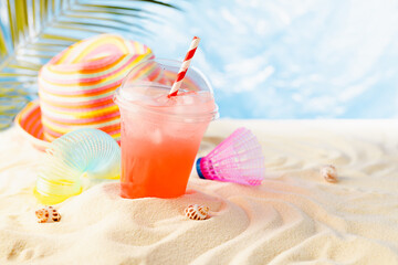 Happiness summer holiday on sunny tropical sea coast under palm with beach games, fresh fruit cold drink and sun hat. Vacation on ocean beach.