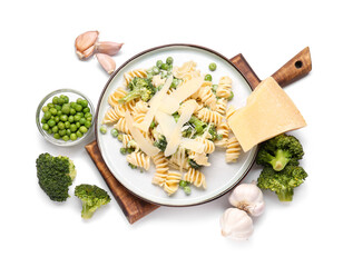 Plate with tasty pasta and vegetables on white background