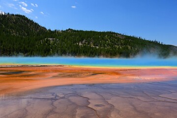 the very colorful grand prismatic spring and microbial mat on a sunny  day in yellowstone national park, wyoming