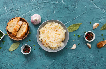 Composition with tasty sauerkraut on color background