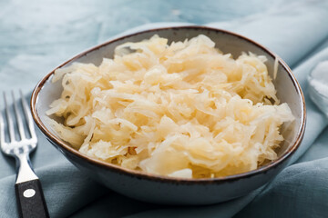 Bowl with tasty sauerkraut on table