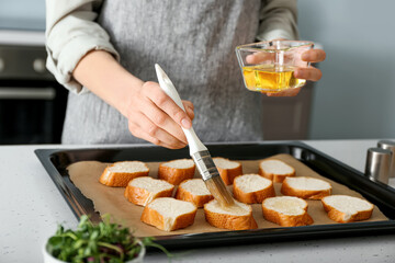 Female chef preparing toasts on kitchen table, closeup