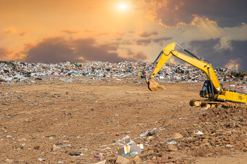 backhoe loader in garbage dump pile in trash dump or landfill,poverty concept and...