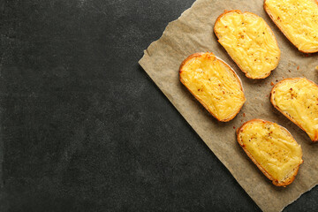 Tasty toasts with cheese on dark background
