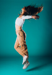 Dancer practicing modern dance isolated on cyan background