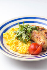 Risotto with pork sausages with cherry tomatoes and parsley on a plate. Italian cuisine concept