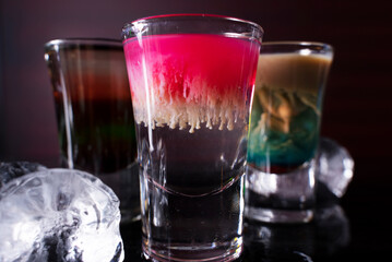 Cocktail shots at the bar counter. Cocktail at the bar. Alcoholic drink at the night club.