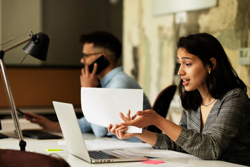Happy businesswoman working on laptop. Portrait of beautiful businesswoman in the office
