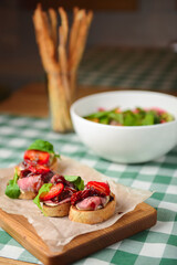 Strawberry bruschetta with prosciutto, goat cheese,basil and fresh nstrawberry on top.